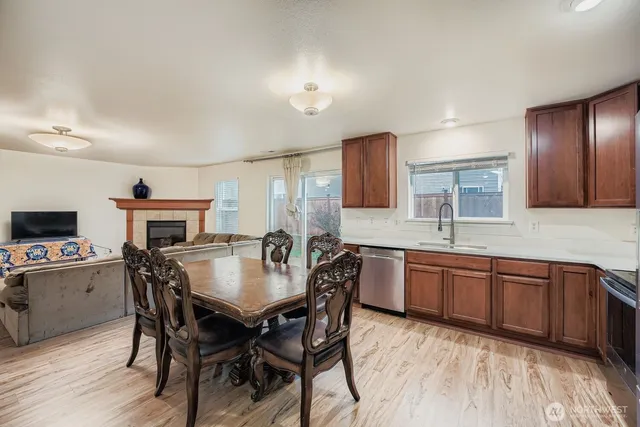 a kitchen with granite countertop a sink and wooden cabinets