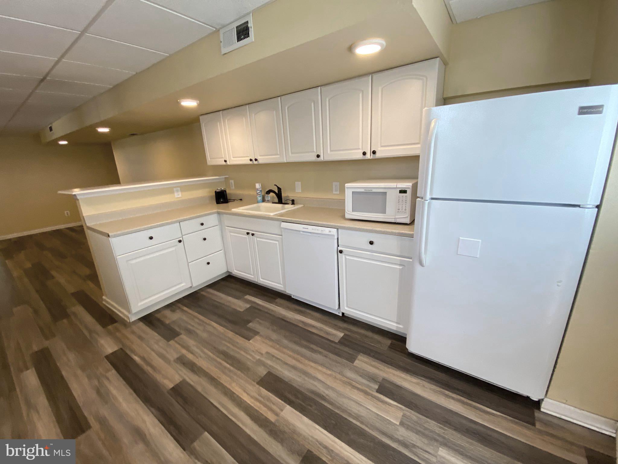 a kitchen with cabinets appliances and a sink