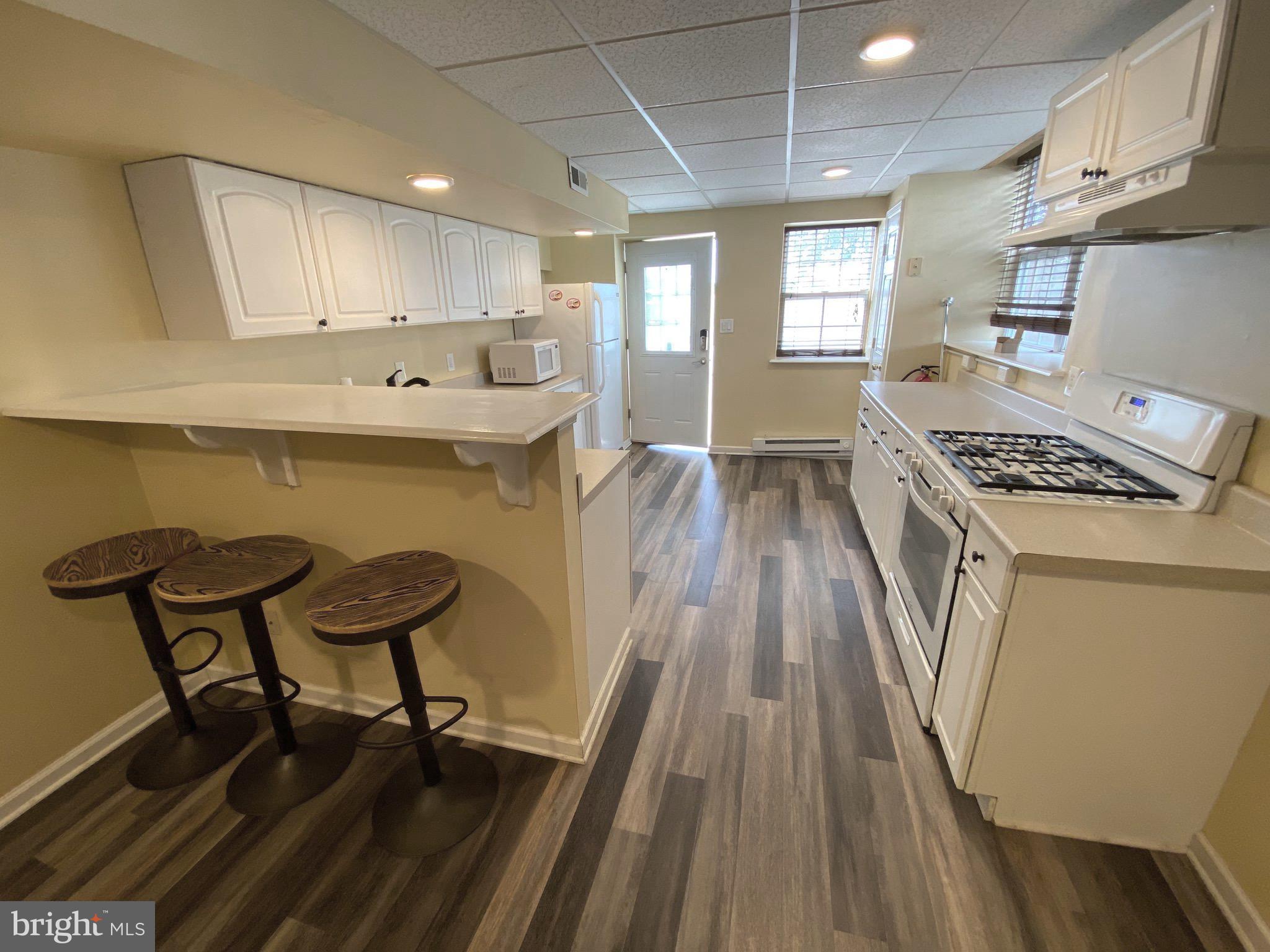 394 Croshaw Road, Unit B Wrightstown, NJ 08562 - Photo 3 of 16 a kitchen with wooden floors and wooden cabinets