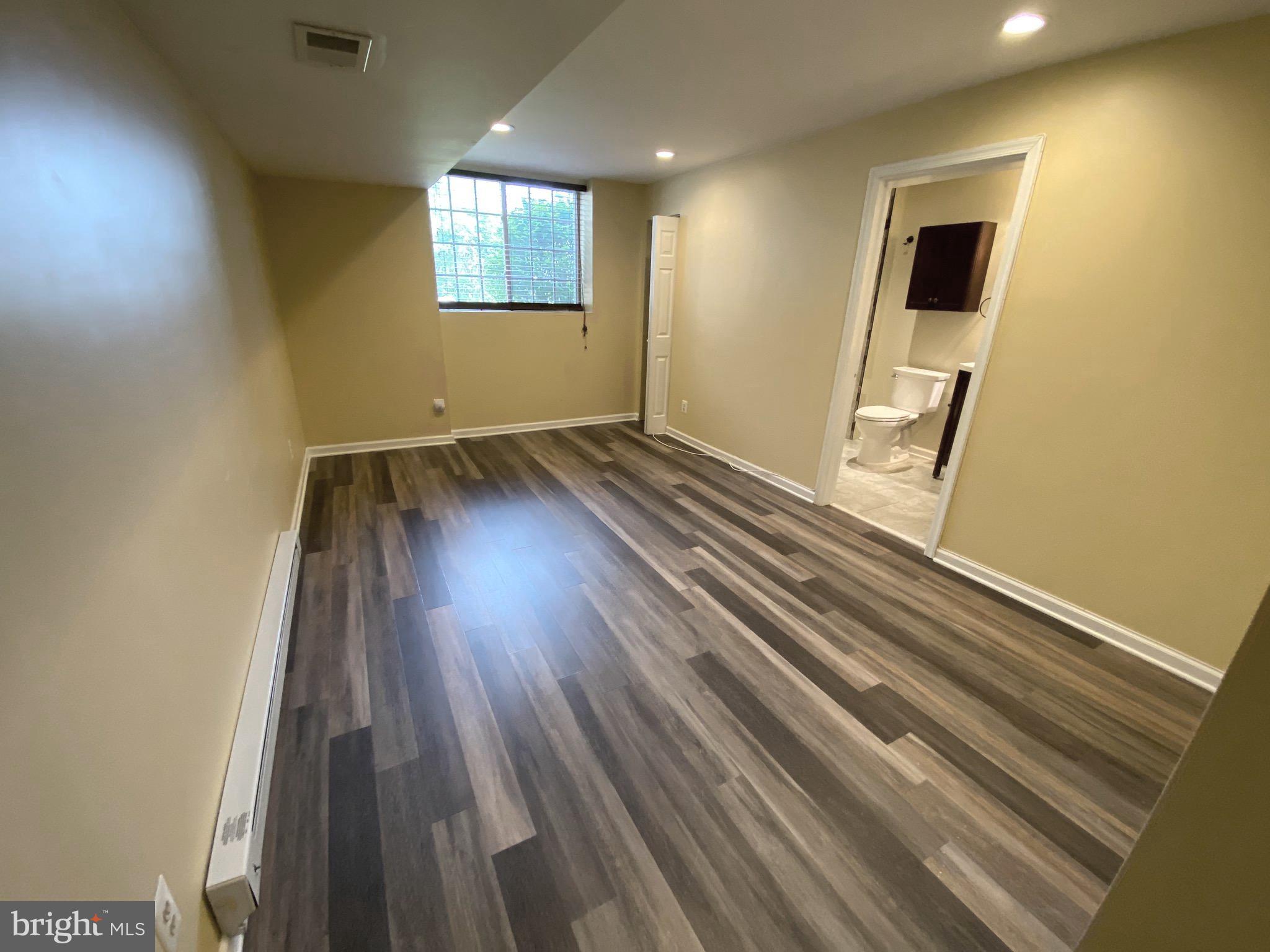 394 Croshaw Road, Unit B Wrightstown, NJ 08562 - Photo 5 of 16 an empty room with wooden floor and windows