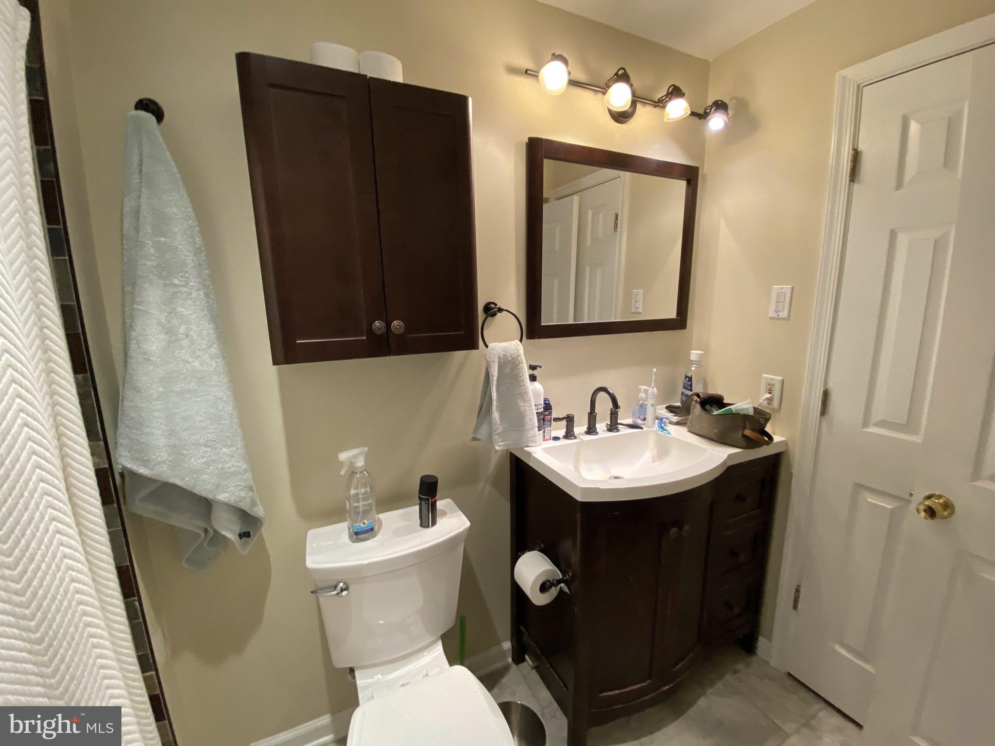 394 Croshaw Road, Unit B Wrightstown, NJ 08562 - Photo 6 of 16 a bathroom with a sink and mirror with toilet