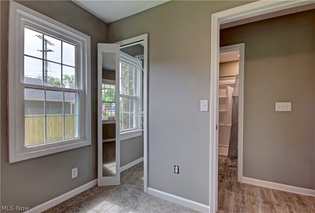 14507 Glencliffe Road Cleveland, OH 44111 - Photo 23 of 31 Unfurnished bedroom featuring carpet, a closet, and a walk in closet