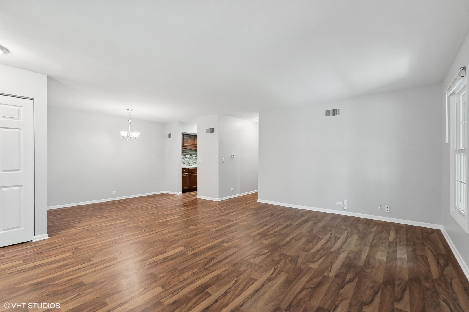 520 Shorely Drive, Unit 201 Barrington, IL 60010 - Photo 3 of 14 a view of an empty room with wooden floor and a window