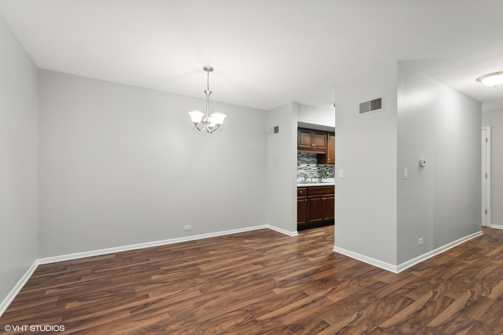 520 Shorely Drive, Unit 201 Barrington, IL 60010 - Photo 4 of 14 wooden floor in an empty room with a window
