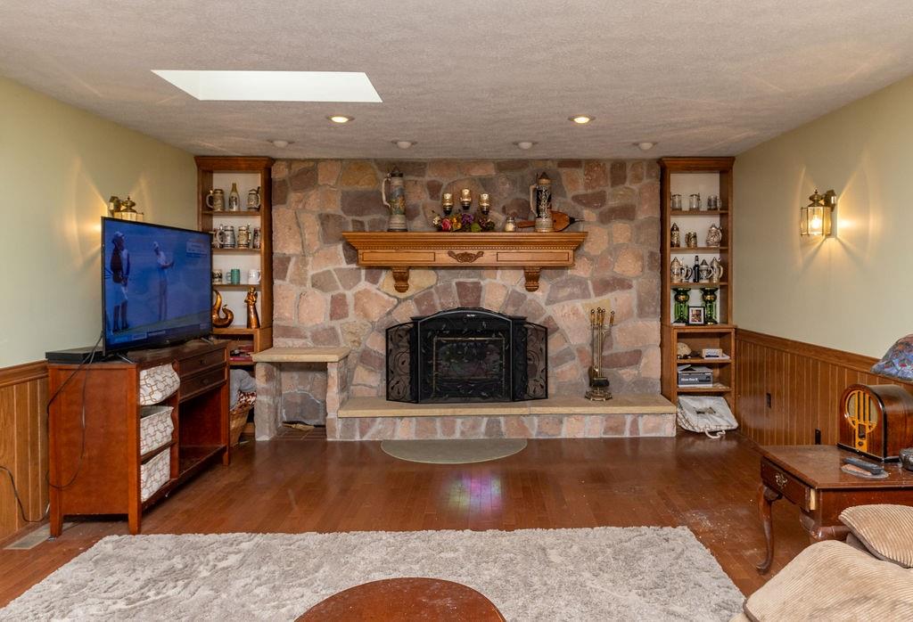 136 Dehaven Road Beaver Falls, PA 15010 - Photo 13 of 25 a living room with furniture a fireplace and a flat screen tv