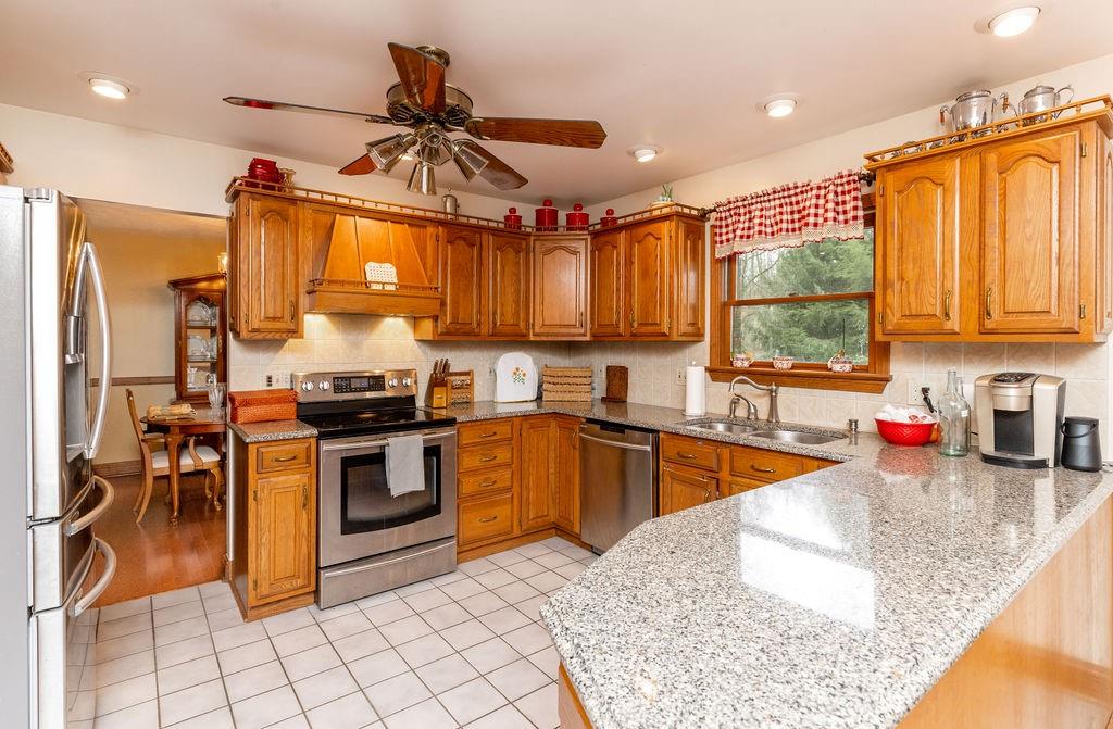 136 Dehaven Road Beaver Falls, PA 15010 - Photo 15 of 25 a kitchen with stainless steel appliances granite countertop a sink stove and refrigerator