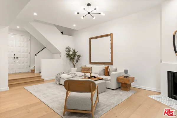 a living room with furniture and a chandelier