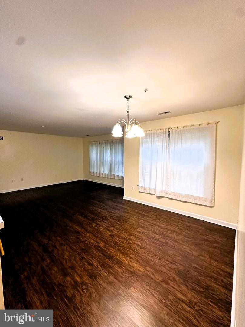 2014 Windsong Drive, Unit 1B Hagerstown, MD 21740 - Photo 3 of 8 a view of an empty room with wooden floor and a window