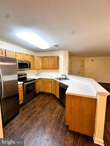 a kitchen with a stove a sink and a refrigerator