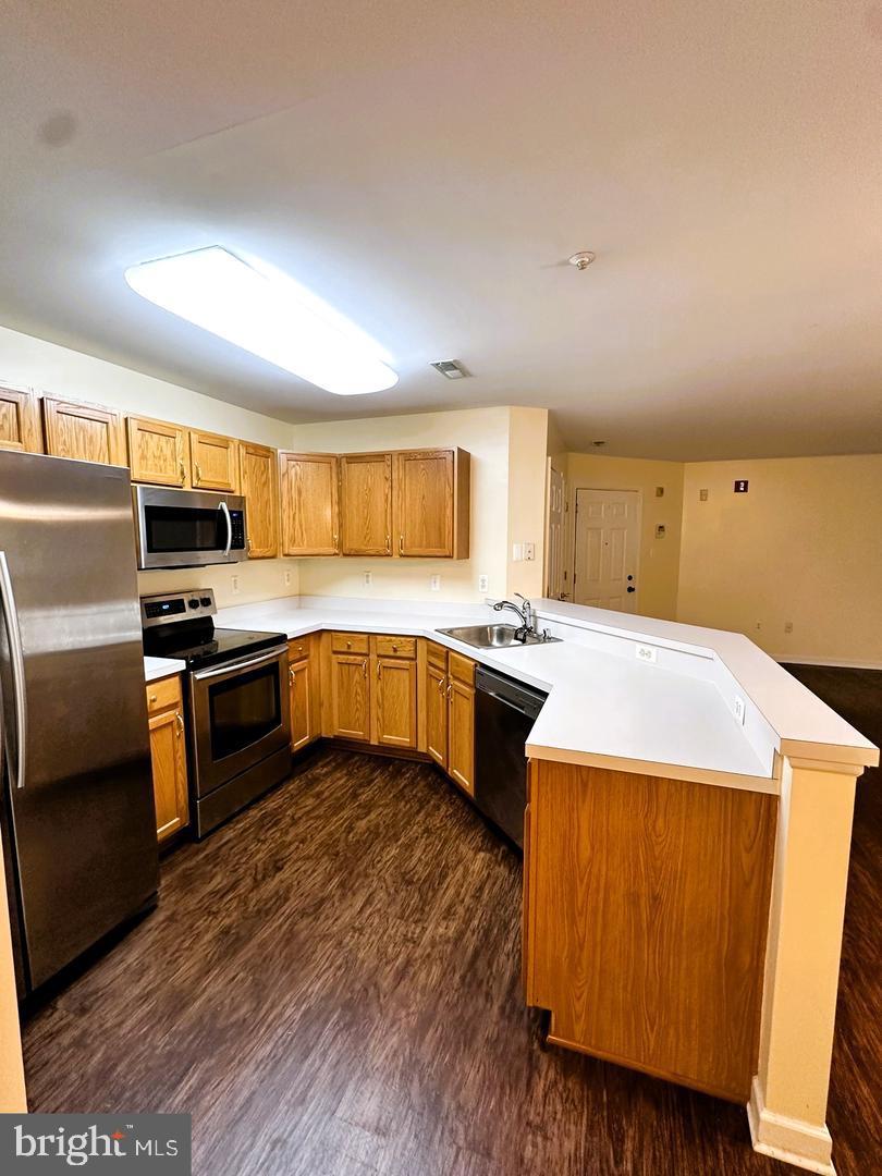 2014 Windsong Drive, Unit 1B Hagerstown, MD 21740 - Photo 5 of 8 a kitchen with a stove a sink and a refrigerator
