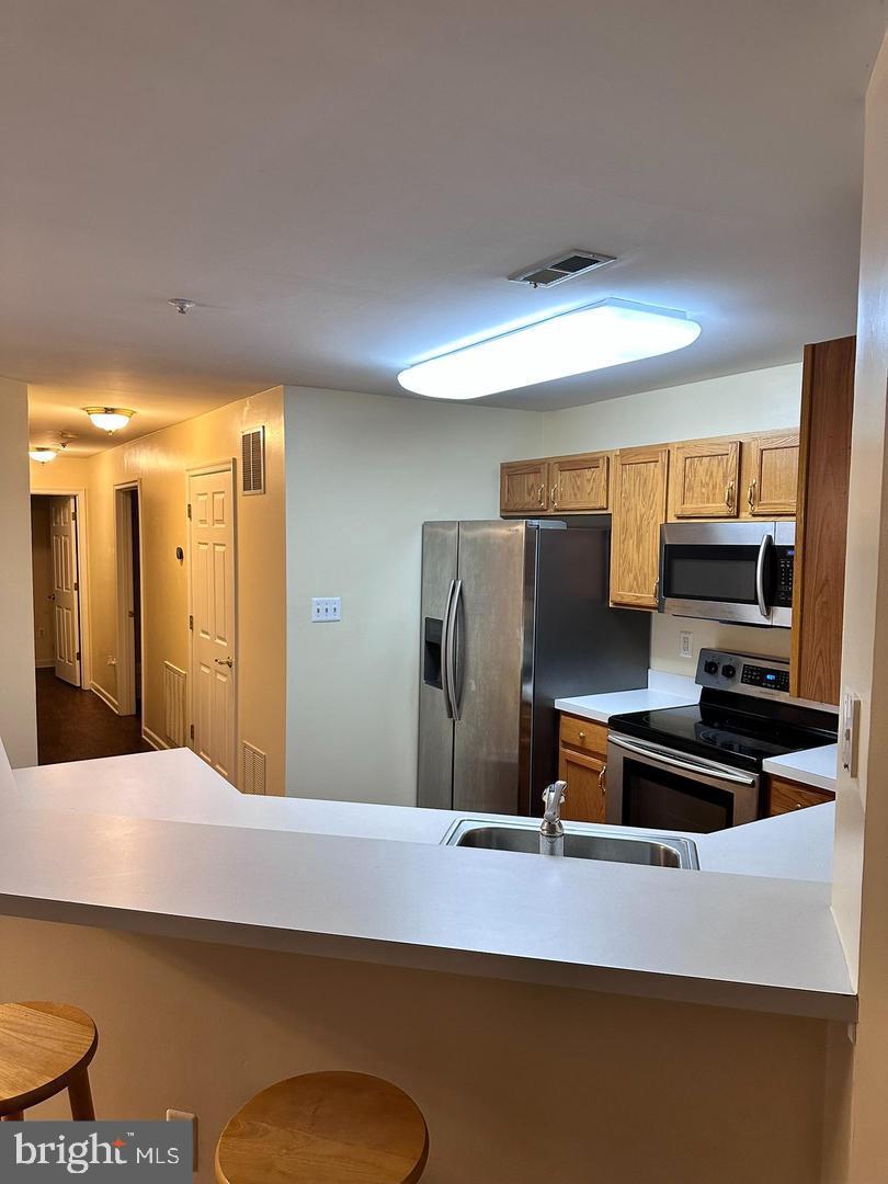 2014 Windsong Drive, Unit 1B Hagerstown, MD 21740 - Photo 6 of 8 a kitchen with stainless steel appliances a refrigerator and a stove