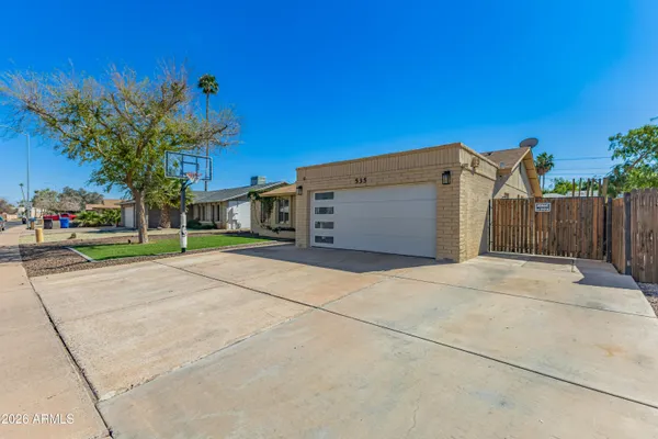 a view of a house with a yard and a garage