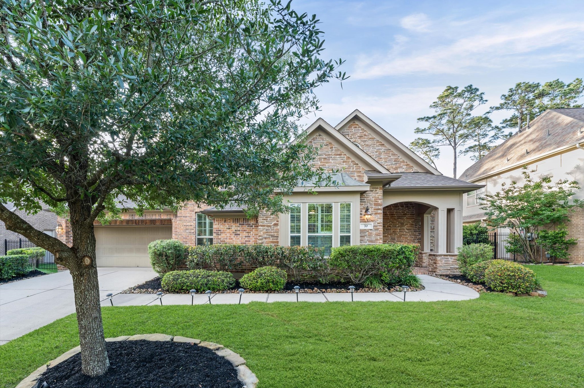 70 Valera Ridge Drive Spring, TX 77389 - Photo 2 of 37 Charming brick home with a manicured front yard and mature trees. Features a spacious driveway leading to a two-car garage and an inviting front entry with a covered porch. Ideal for comfortable living in a serene neighborhood.