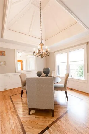 a living room with furniture a window and wooden floor