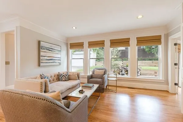a living room with furniture and floor to ceiling windows