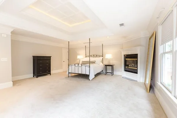 a view of a livingroom with a fireplace and window