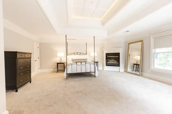 a view of a bedroom with furniture and window