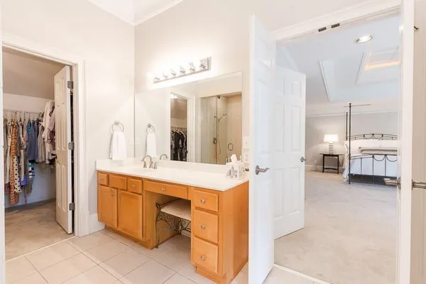 a view of a bathroom with a sink and mirror with shower