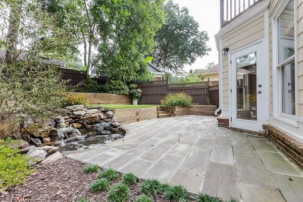 a view of a backyard with sitting area