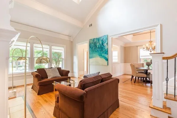 a living room with furniture and floor to ceiling windows