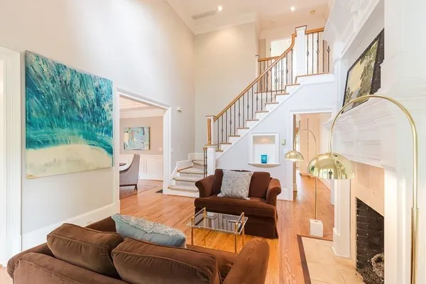 a living room with furniture and a chandelier
