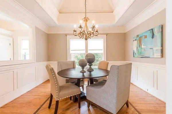 a dining room with furniture and window