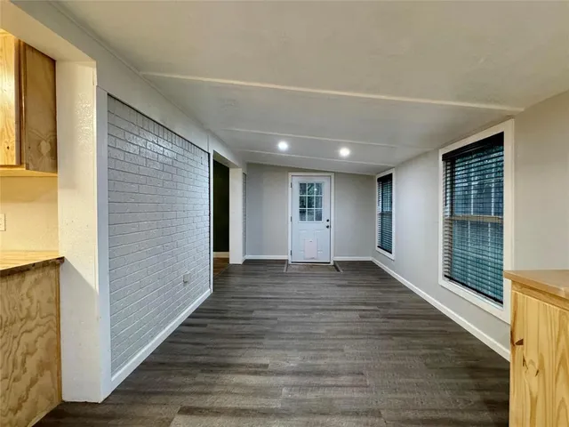 a view of a kitchen with wooden floor