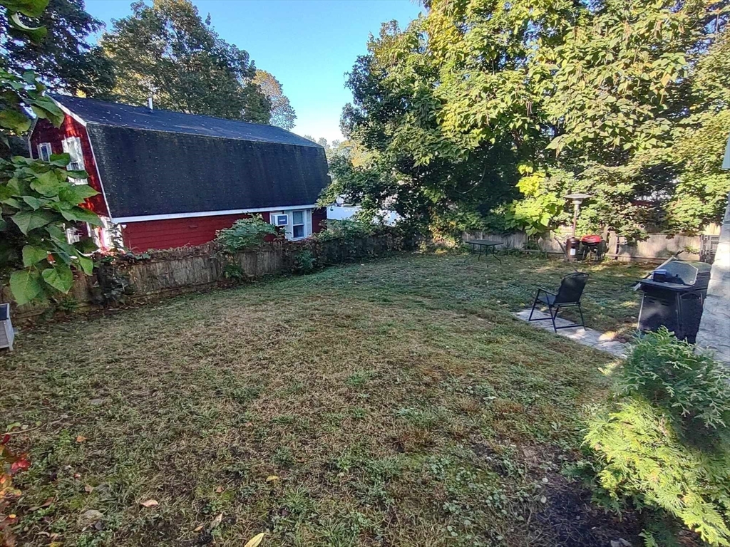 16 Kilby Street, Unit 3 Woburn, MA 01801 - Photo 11 of 12 a backyard of a house with lots of green space