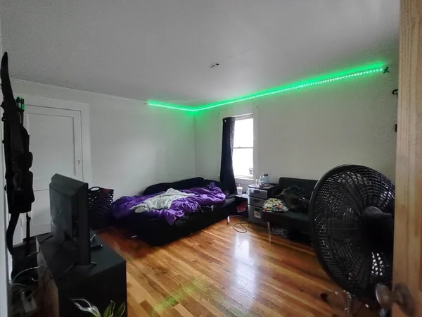 a bedroom with furniture and a wooden floor