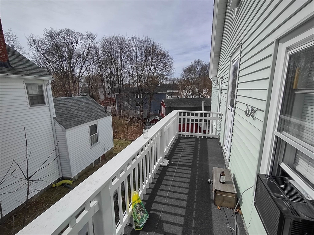 16 Kilby Street, Unit 3 Woburn, MA 01801 - Photo 6 of 12 a view of balcony with wooden floor and fence