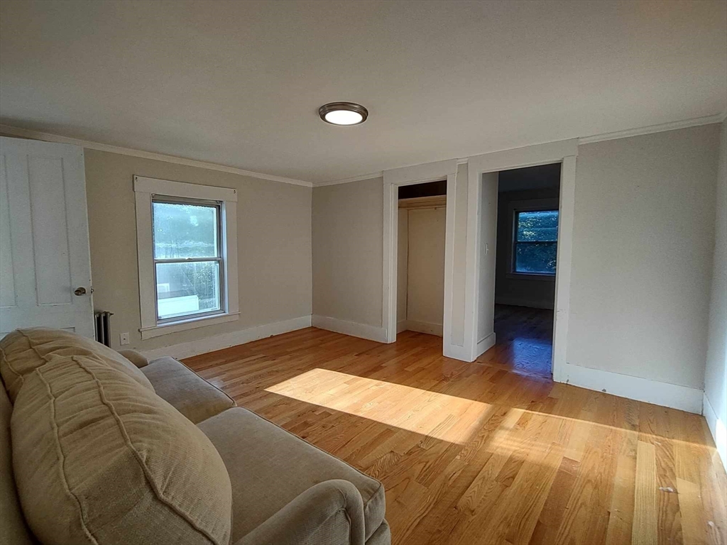 16 Kilby Street, Unit 3 Woburn, MA 01801 - Photo 8 of 12 a bed sitting in a bedroom next to a window