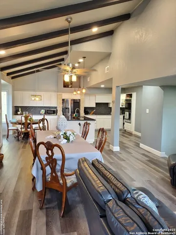 a large kitchen with a table and chairs