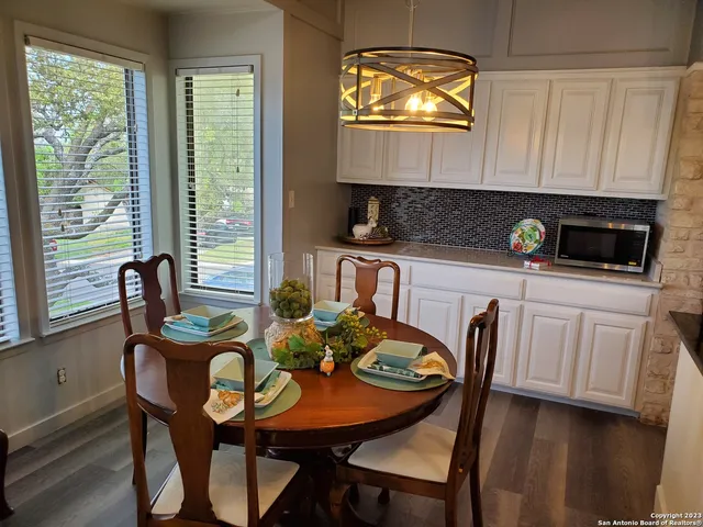 a kitchen with a table chairs and a stove