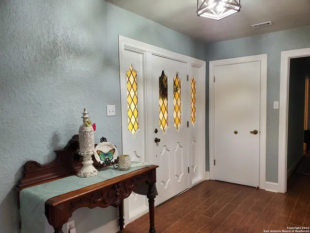 a view of a workspace with furniture and wooden floor
