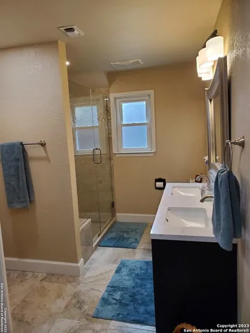 a bathroom with a sink vanity mirror and toilet