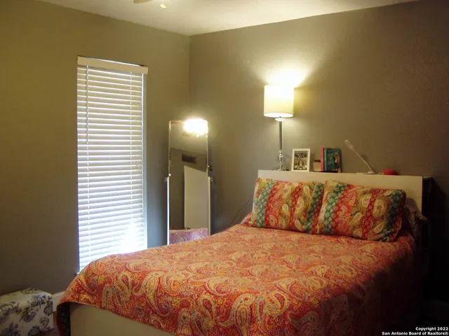 a view of a backyard with a wooden fence