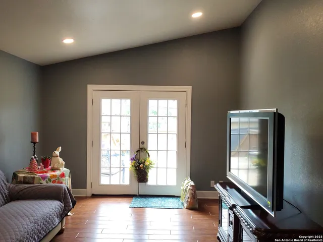 a living room with furniture and a flat screen tv