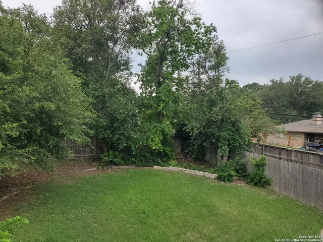 a view of a park with trees and flowers