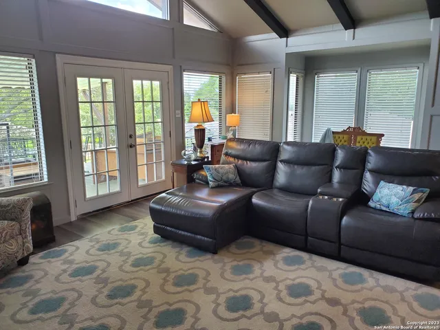 a living room with furniture and large windows