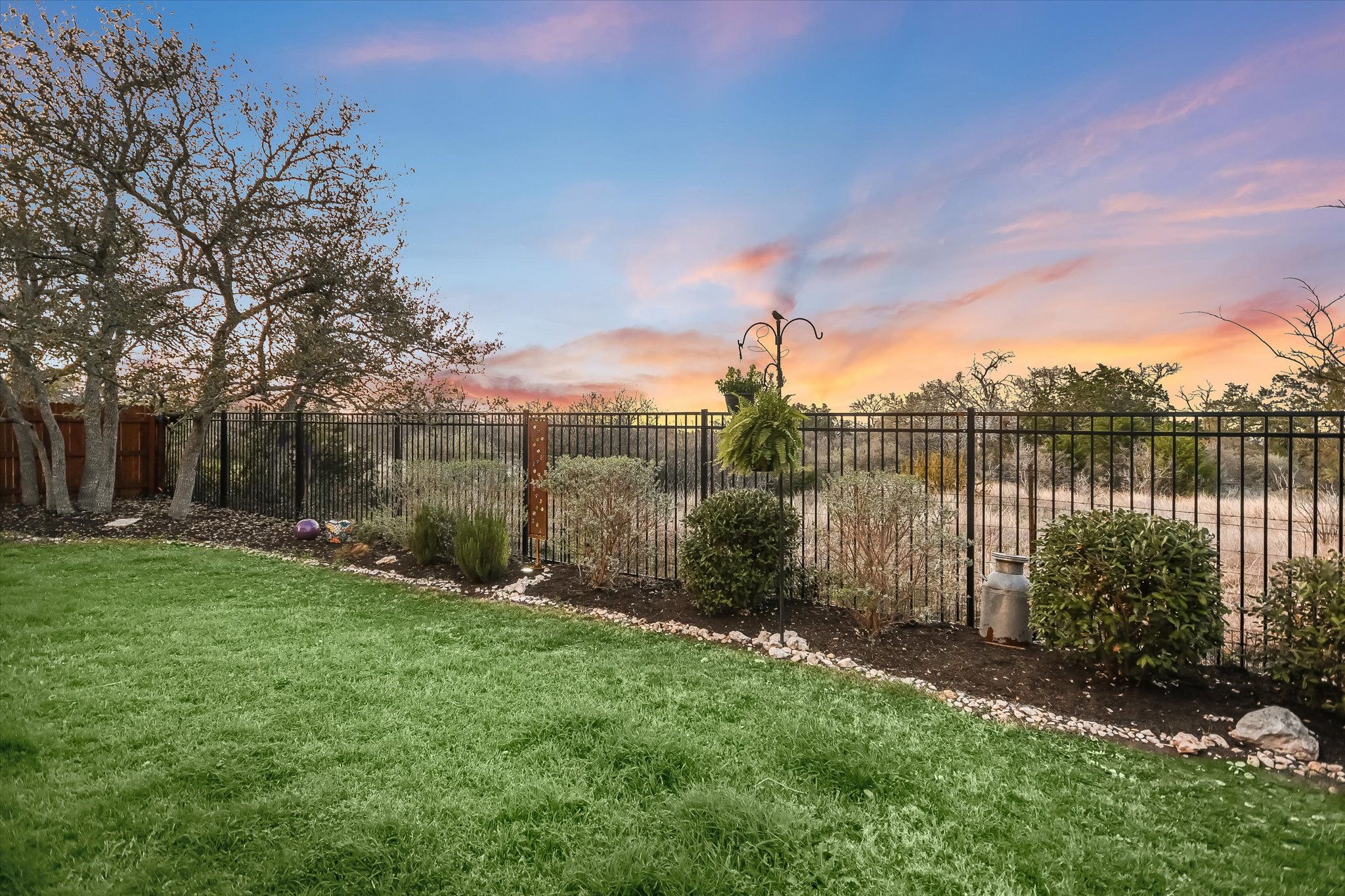 508 Peakside Circle Dripping Springs, TX 78620 - Photo 28 of 30 Yard at dusk with a fenced backyard