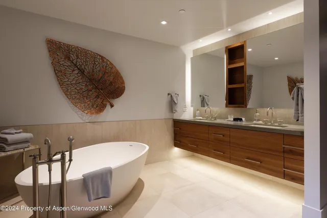 a bathroom with a tub sink and mirror