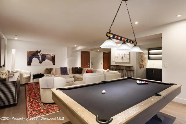 a living room with lots of furniture and a chandelier