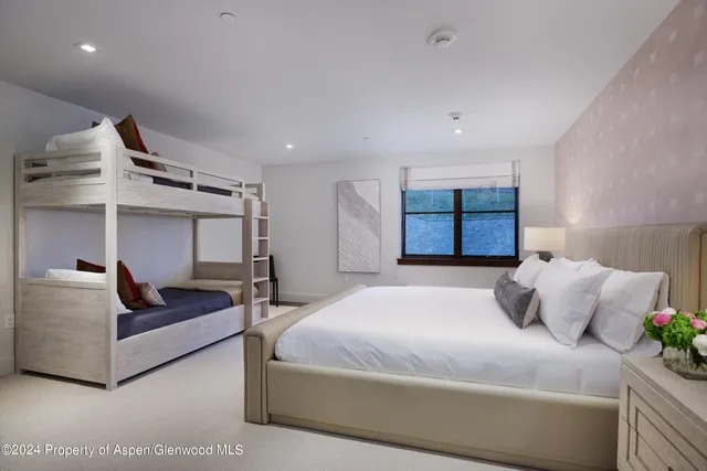 a bedroom with a bed couch and window