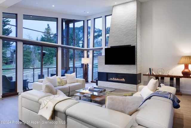 a living room with furniture tv and a window