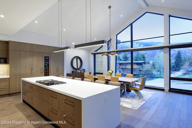 a room with furniture a large window and wooden floors