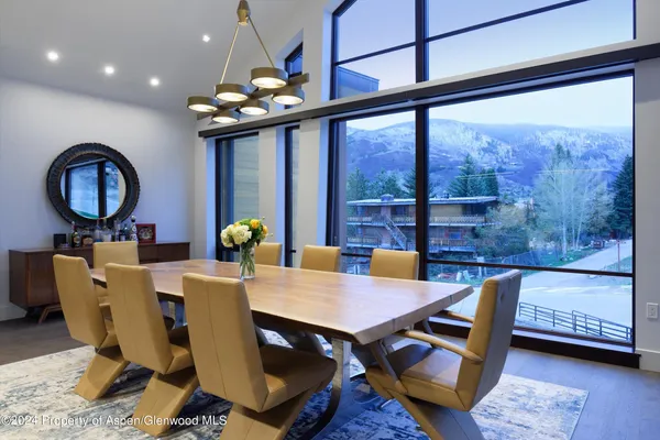 a view of a dining room with furniture wooden floor and a chandelier
