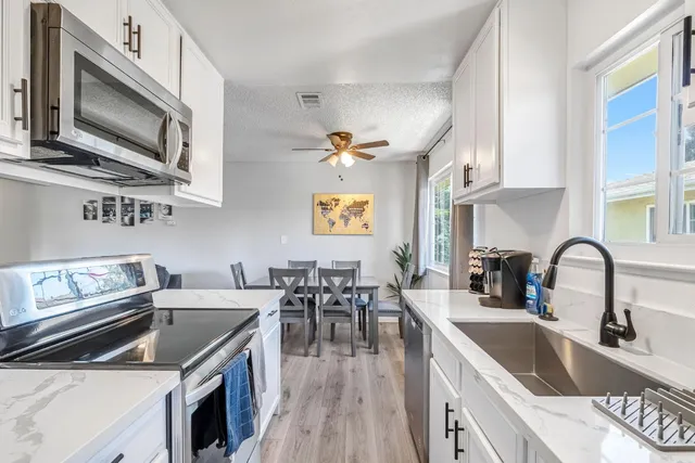 a kitchen with a stove a sink and a microwave