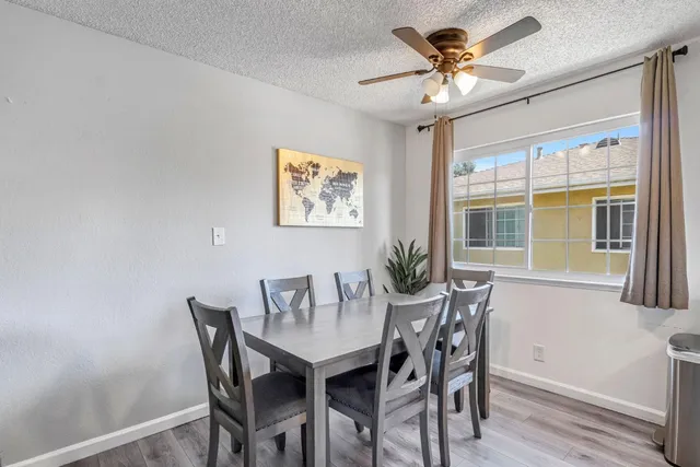 a view of a dining room with furniture and a chandelier