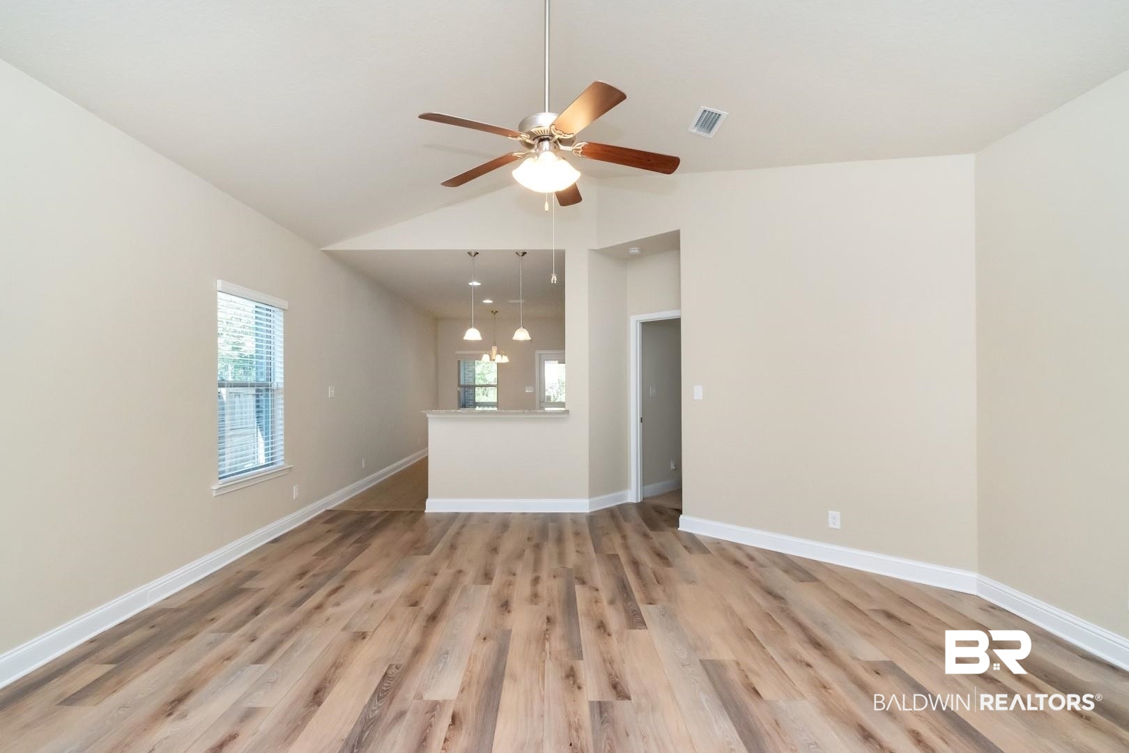 6144 Whitebark Drive Mobile, AL 36693 - Photo 4 of 33 Unfurnished living room with light wood-type flooring, vaulted ceiling, and ceiling fan