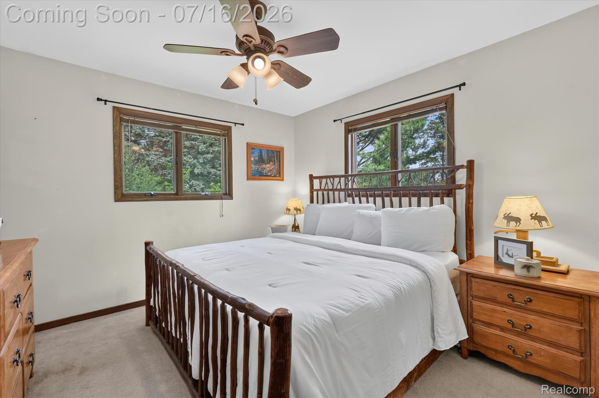11210 Linden Road Linden, MI 48451 - Photo 14 of 61 Carpeted bedroom featuring two windows with wood trim, a ceiling fan with integrated lighting, and light-toned walls